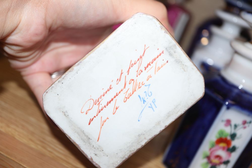 A collection of French porcelain scent bottles and a teapot (24)